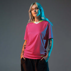 Model wearing PowerPlay V-Neck Jersey in hyper pink with neon accents, showcasing stylish sportswear for women.