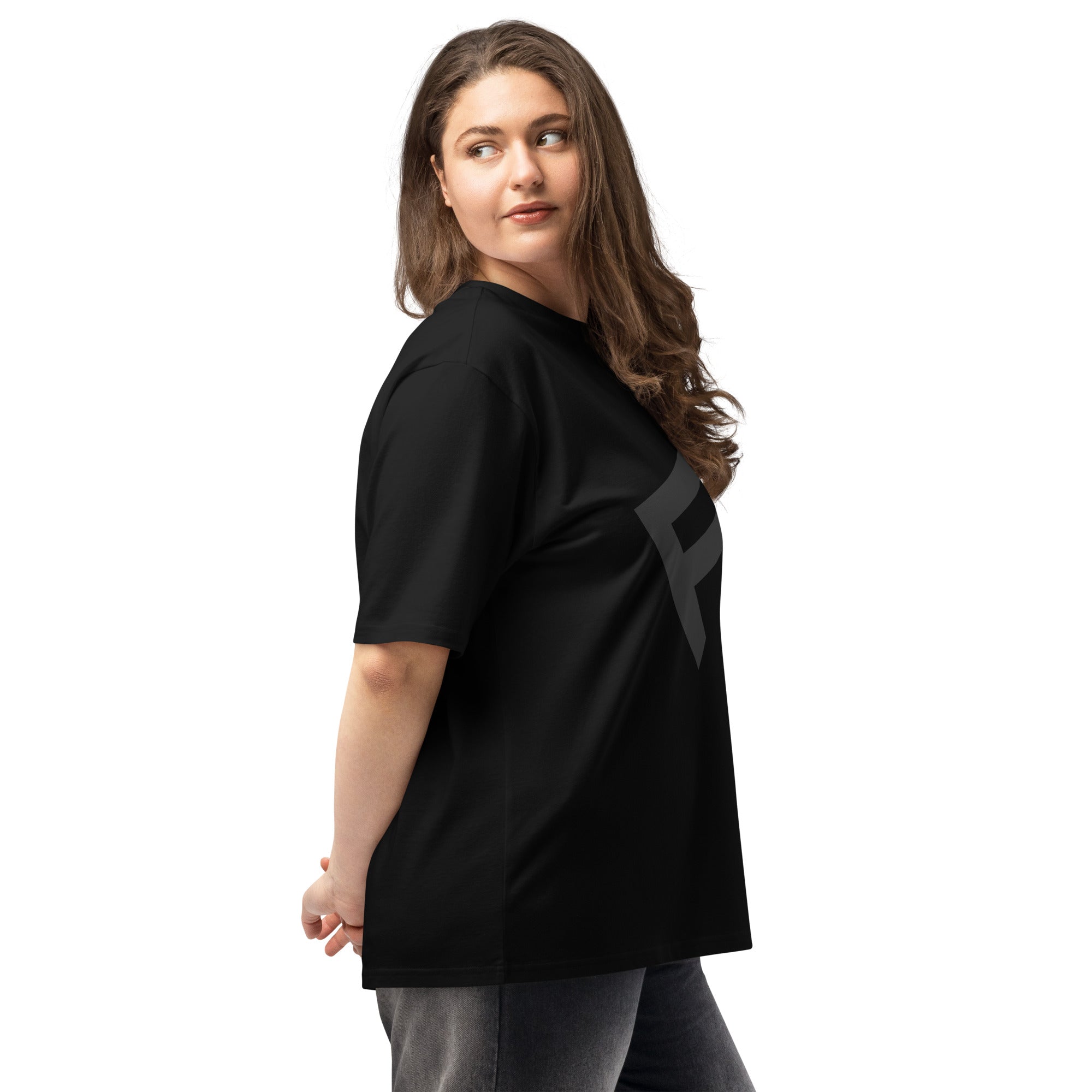 Woman wearing the StreetCore Oversized Drop Shoulder Fit black tee, showcasing relaxed streetwear style.
