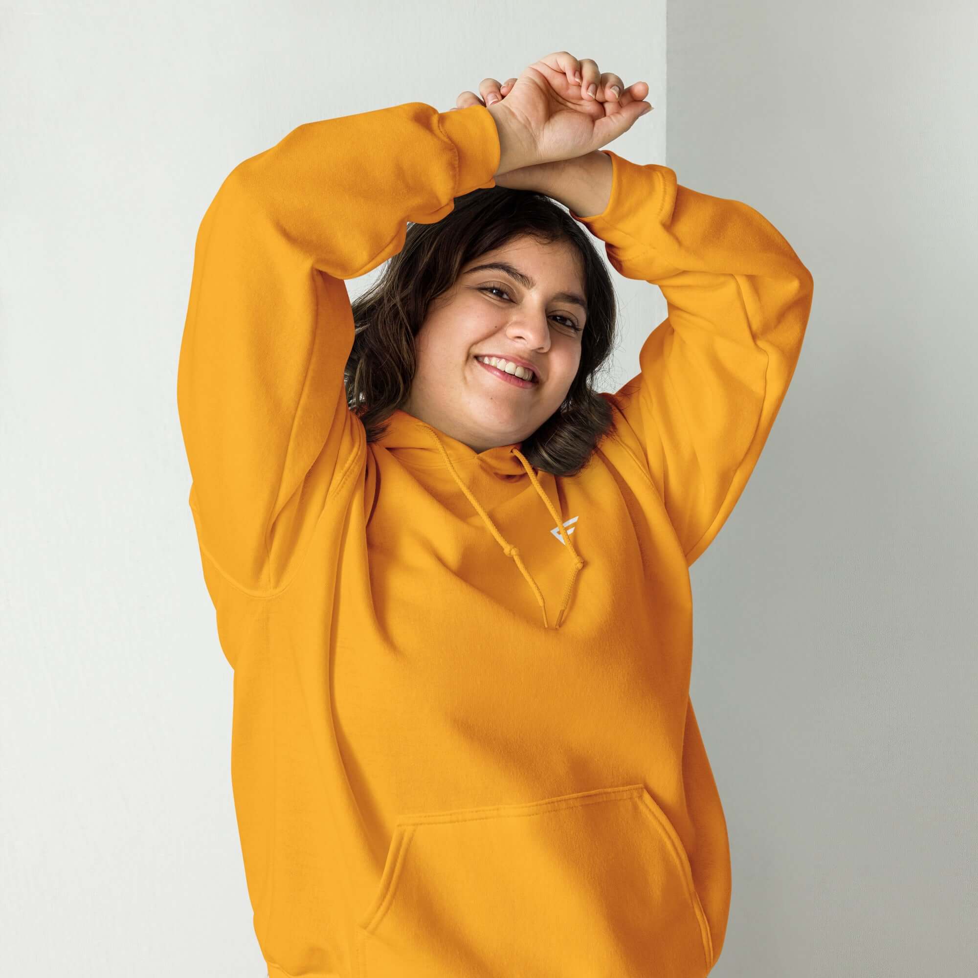 Smiling person wearing a soft orange hoodie, perfect for everyday comfort and casual style.