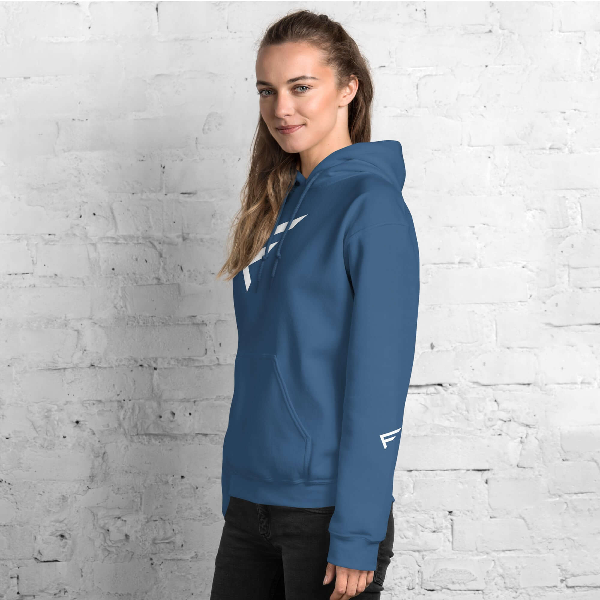 Woman wearing a blue hoodie with signature 'F' emblem, perfect for comfort and style.