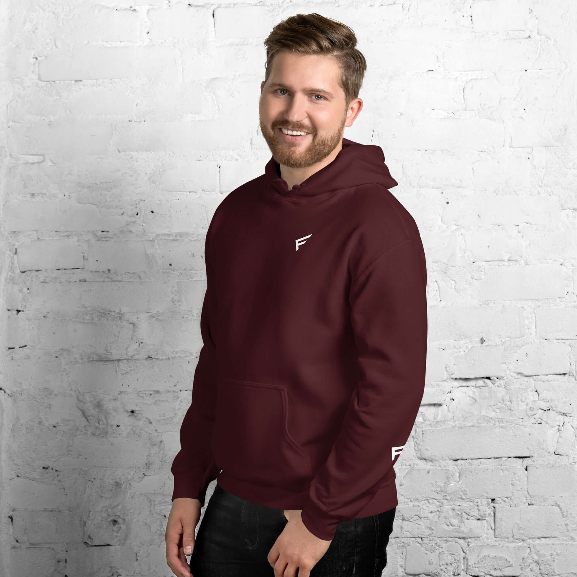 Man wearing a men's maroon hoodie from the Core Collection, featuring a soft cotton blend and stylish design.