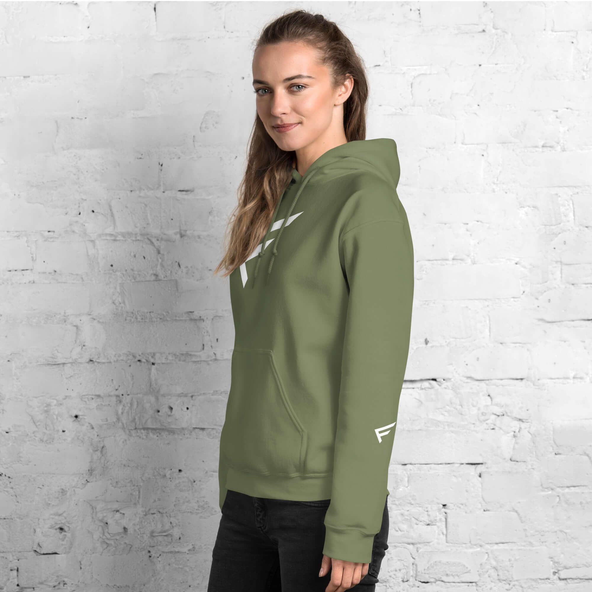 Woman wearing limited drop hoodie with signature F emblem, showcasing comfort and style.
