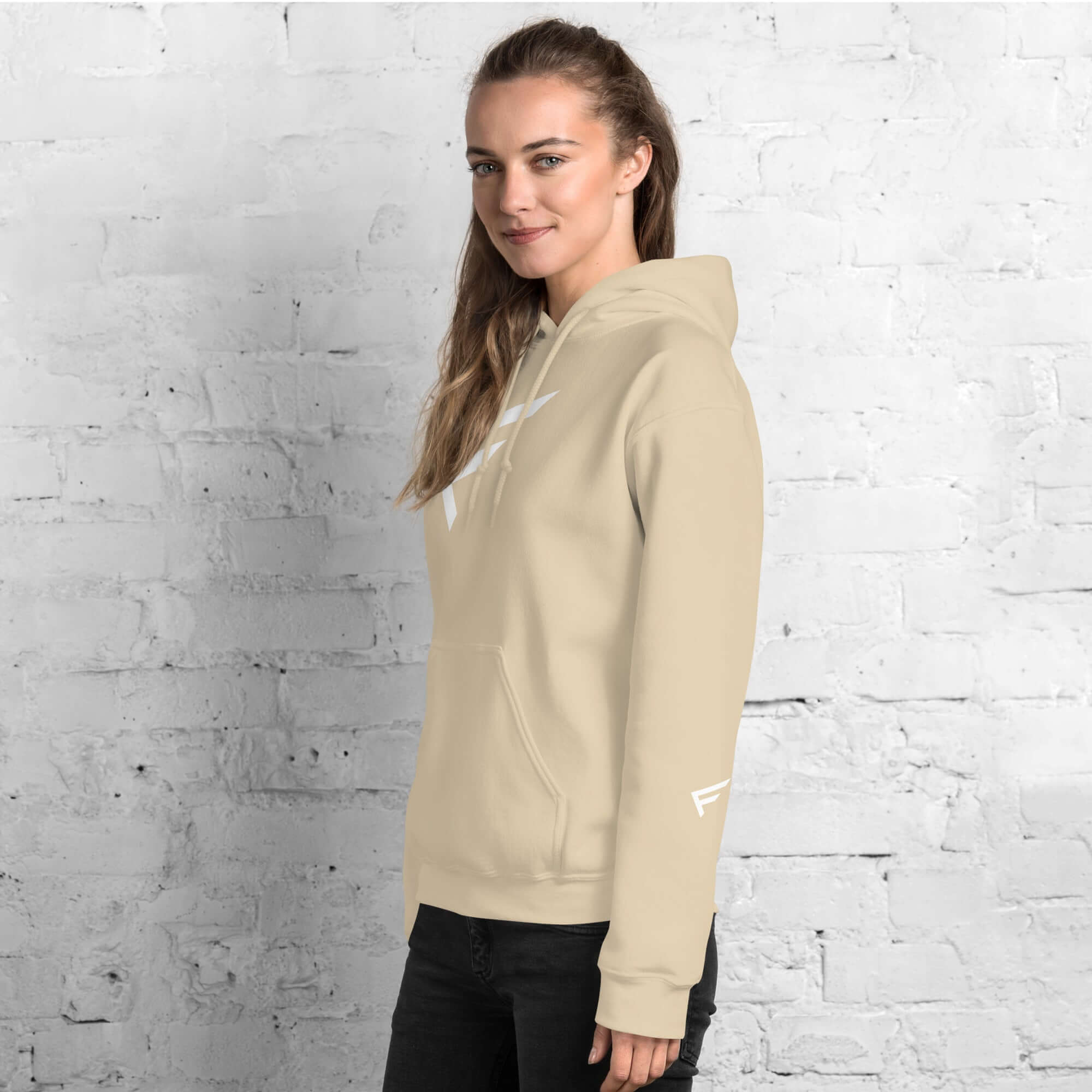 Women's beige hoodie featuring signature 'F' emblem, designed for comfort and bold movement.